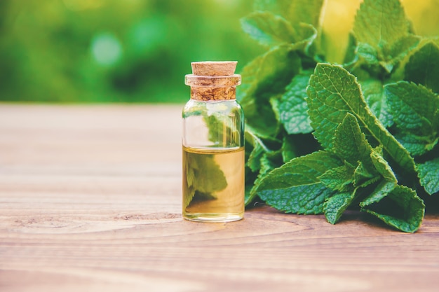 The mint extract in a small jar. Selective focus.