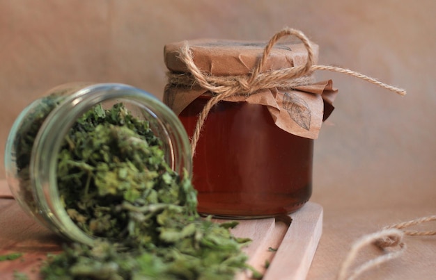 Mint leaf syrup in a glass jar with dry mint leaves