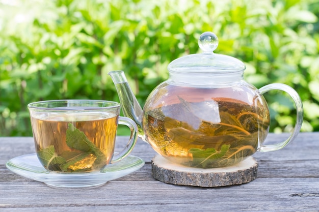 mint tea in tea pot and cup outdoors