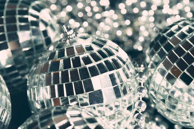 Mirror balls reflecting lights close up nightlife background