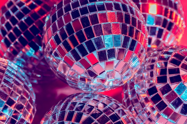 Mirror disco balls over pink background. Party, nightlife concept