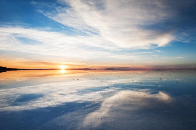 Mirror surface on the salt flat Salar de Uyuni at sunrise, Altiplano, Bolivia