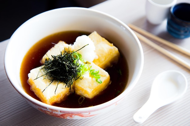 Miso soup is a Japanese soup made from a dashi broth and miso paste, which gives it its name.