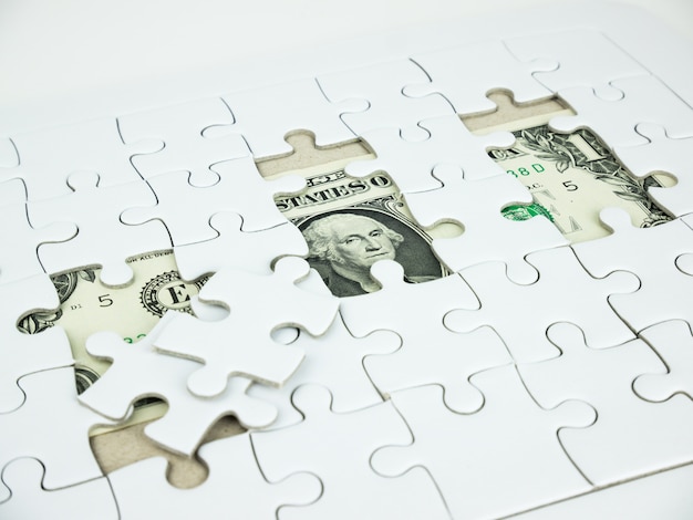 Photo missing jigsaw puzzle pieces on dollar money background