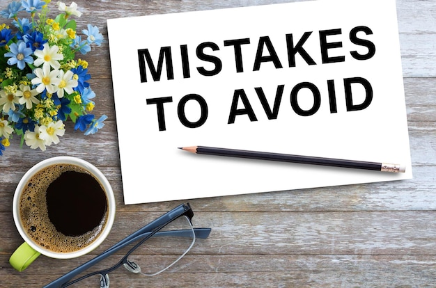 MISTAKES TO AVOIDText on notebook in office desk workplace background