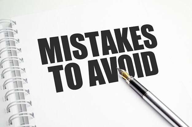 Mistakes word message on white paper book and copy space on white desk