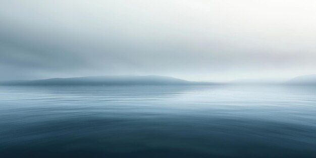 Photo misty morning over calm sea with distant horizon and soft sky reflections