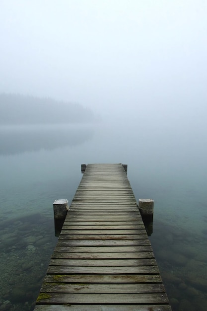 Misty Morning at a Wooden Dock on a Serene Lake