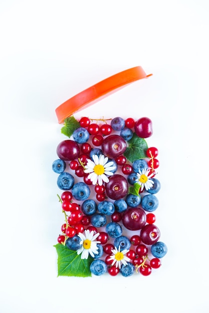 Mix of fresh berries in the form of a jar Flat lay white background