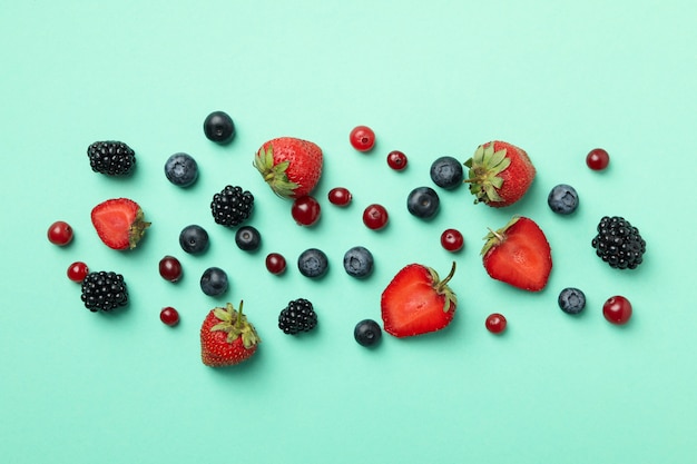 Mix of fresh berries on mint, top view