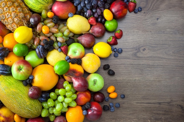 Mix of Fresh Fruits on dark wooden table