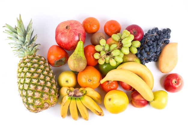 Mix of fresh juicy colorful exotic tropical fruits on white background top view