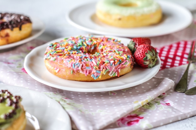 Mix of multicolored sweet donuts with colored sprinkles