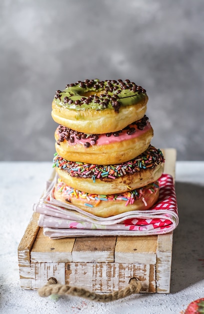 Mix of multicolored sweet donuts with colored sprinkles