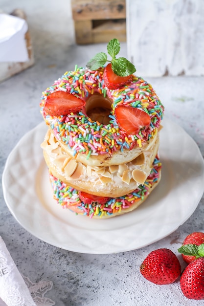 Mix of multicolored sweet donuts with colored sprinkles