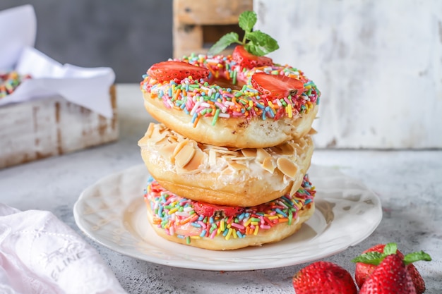 Mix of multicolored sweet donuts with colored sprinkles