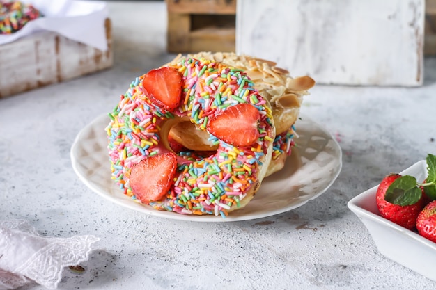 Mix of multicolored sweet donuts with colored sprinkles