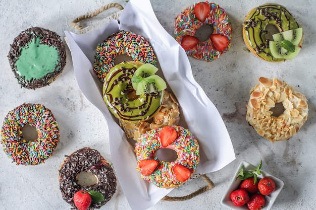 Mix of multicolored sweet donuts with colored sprinkles