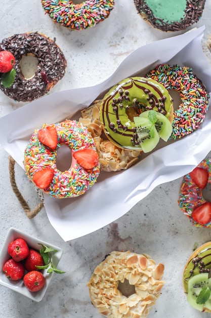 Mix of multicolored sweet donuts with colored sprinkles