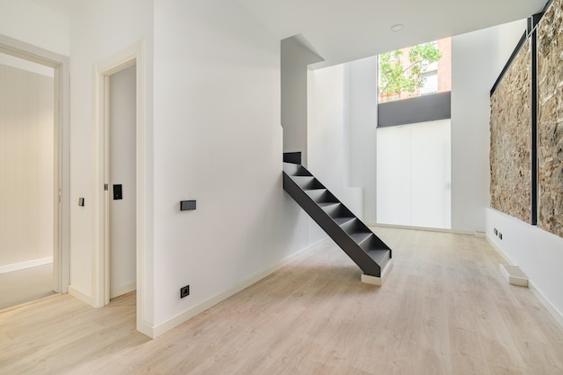 Mix of new and old architecture refurbished apartment with restored ancient wall left from old city ...