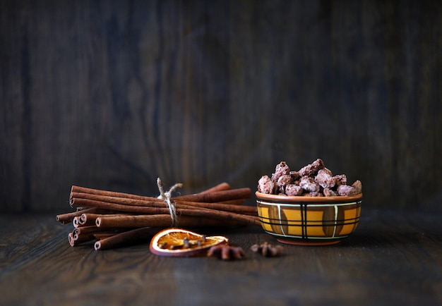 Mix nuts dry fruits and chocolate at ceramic bowl on the wooden table rustic style tasty and delicio...