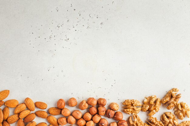 Mix of nuts. Frame made of almonds, hazelnuts and walnuts. Healthy snacks, vegetarianism. Copy space.