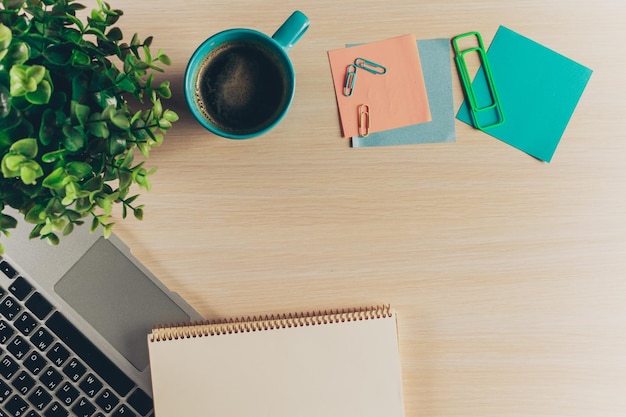 Mix of office supplies and gadgets on a wooden table background