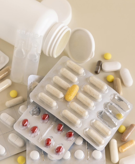 Mix of pills and capsules in a used plastic blisters close up Taking dietary supplements