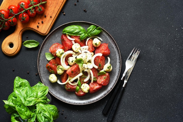 Mix salad with mozzarella tomatoes and pesto sauce Caprese appetizer with pesto