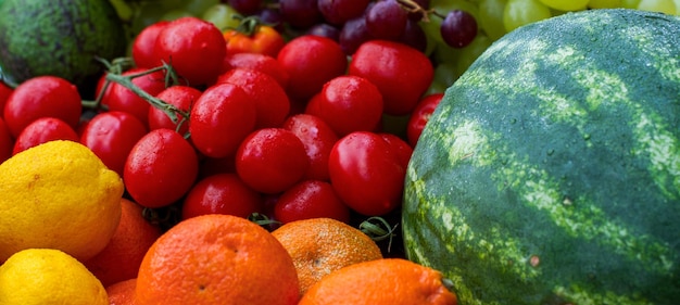 Mix set of vegetables and fruits Vitamin boom Closeup of vegetables and fruits Watermelon tomatoes and oranges