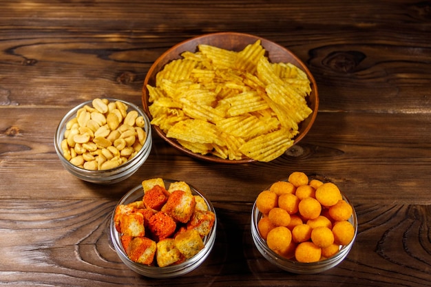 Mix of snacks for beer on wooden table