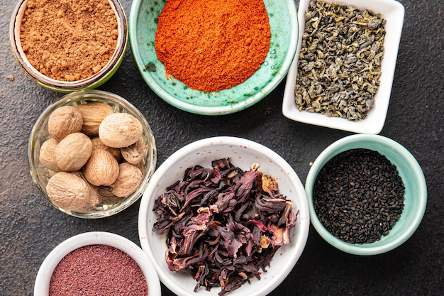 Mix spices seasoning different types pungent and spicy fresh herbs ground spice on the table