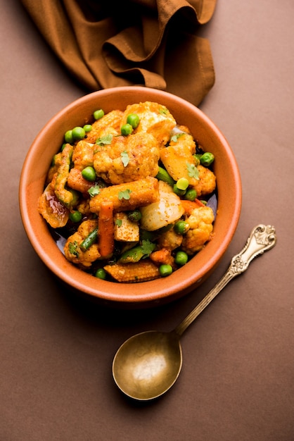 Mix vegetable curry - Indian main course recipe contains Carrots, cauliflower, green peas and beans, baby corn, capsicum and paneer or cottage cheese with traditional masala and curry