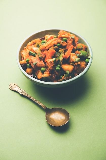 Mix vegetable curry - Indian main course recipe contains Carrots, cauliflower, green peas and beans, baby corn, capsicum and paneer or cottage cheese with traditional masala and curry