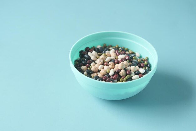 mixed beans in a bowl on light green background