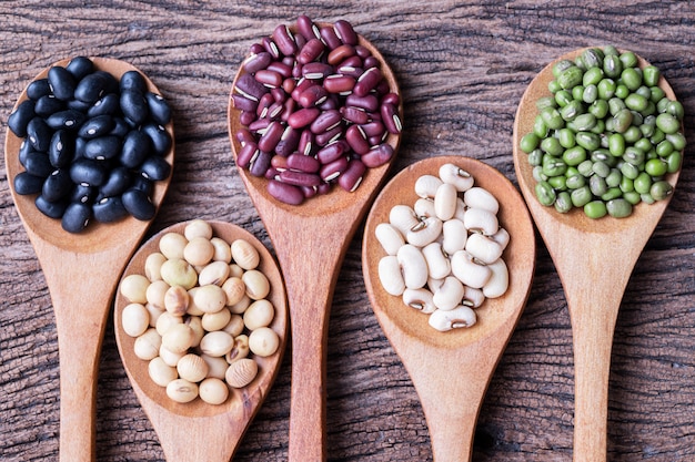 Mixed beans on wood table.