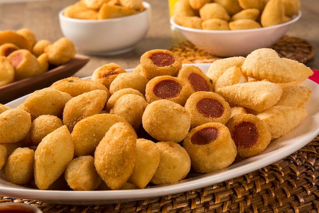 Mixed brazilian snacks fried on wooden background.