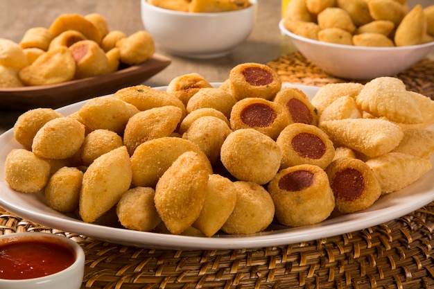 Mixed brazilian snacks fried on wooden background.