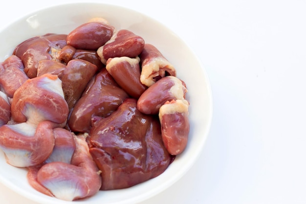 Mixed chicken entrails in white plate on white background