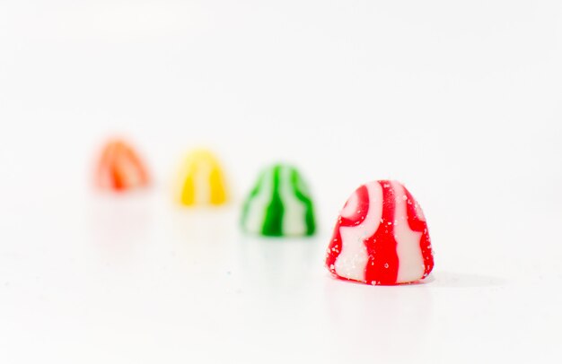 Mixed colorful candies isolated on white background. Close up.