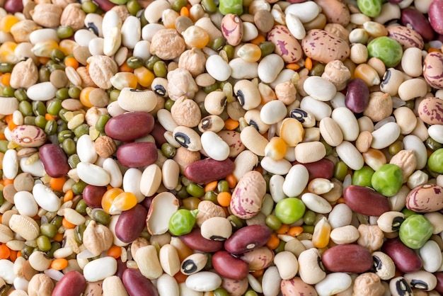 Mixed dried legumes and cereals isolated on white background, top view