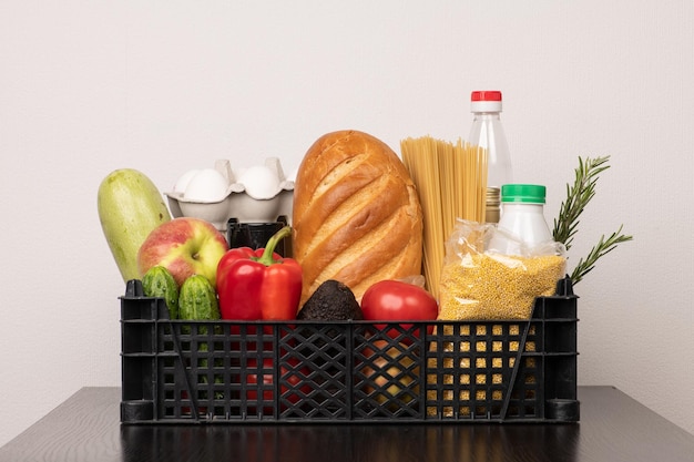 Mixed food basket with bread vegetables sauces eggs and millet