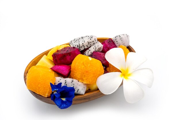 Mixed fruit in Wooden bowl isolated on white background.