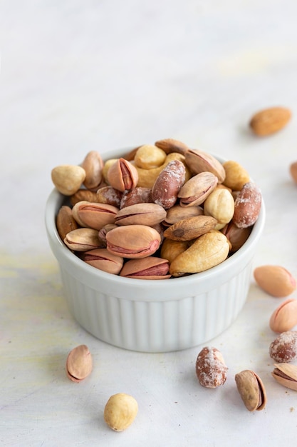 Mixed nuts in bowl on white background