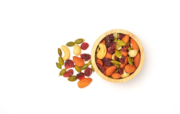 Mixed nuts in white wooden bowl on white background macadamia almonds hazelnuts and cashew top view