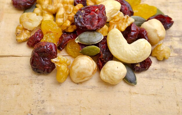 mixed nuts with raisins close up shoot on wooden background