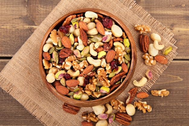 Mixed nuts in wooden bowl with linen mat