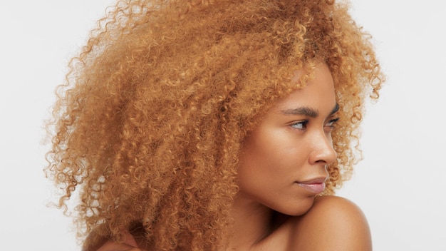 Mixed race black blonde model with curly hair watching to the right