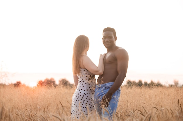 Mixed race young adult couple in wheat field