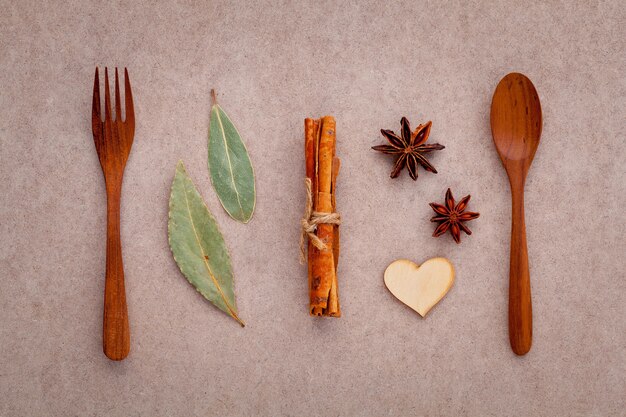 Mixed spices and herbs on brown background .